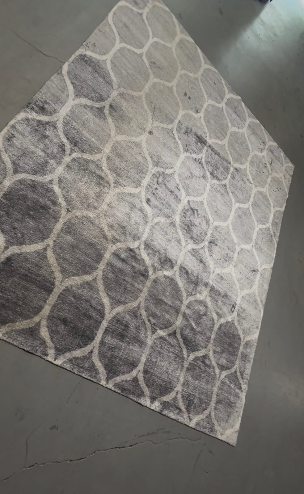 Gray trellis rug after cleaning with yellow staining removed